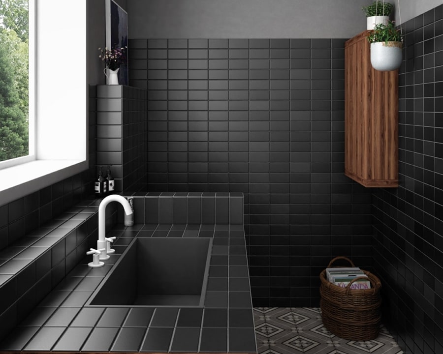 Ściany i blat w łazience wyłożone czarnymi, matowymi płytkami. Stylowe wnętrze z drewnianymi dodatkami.